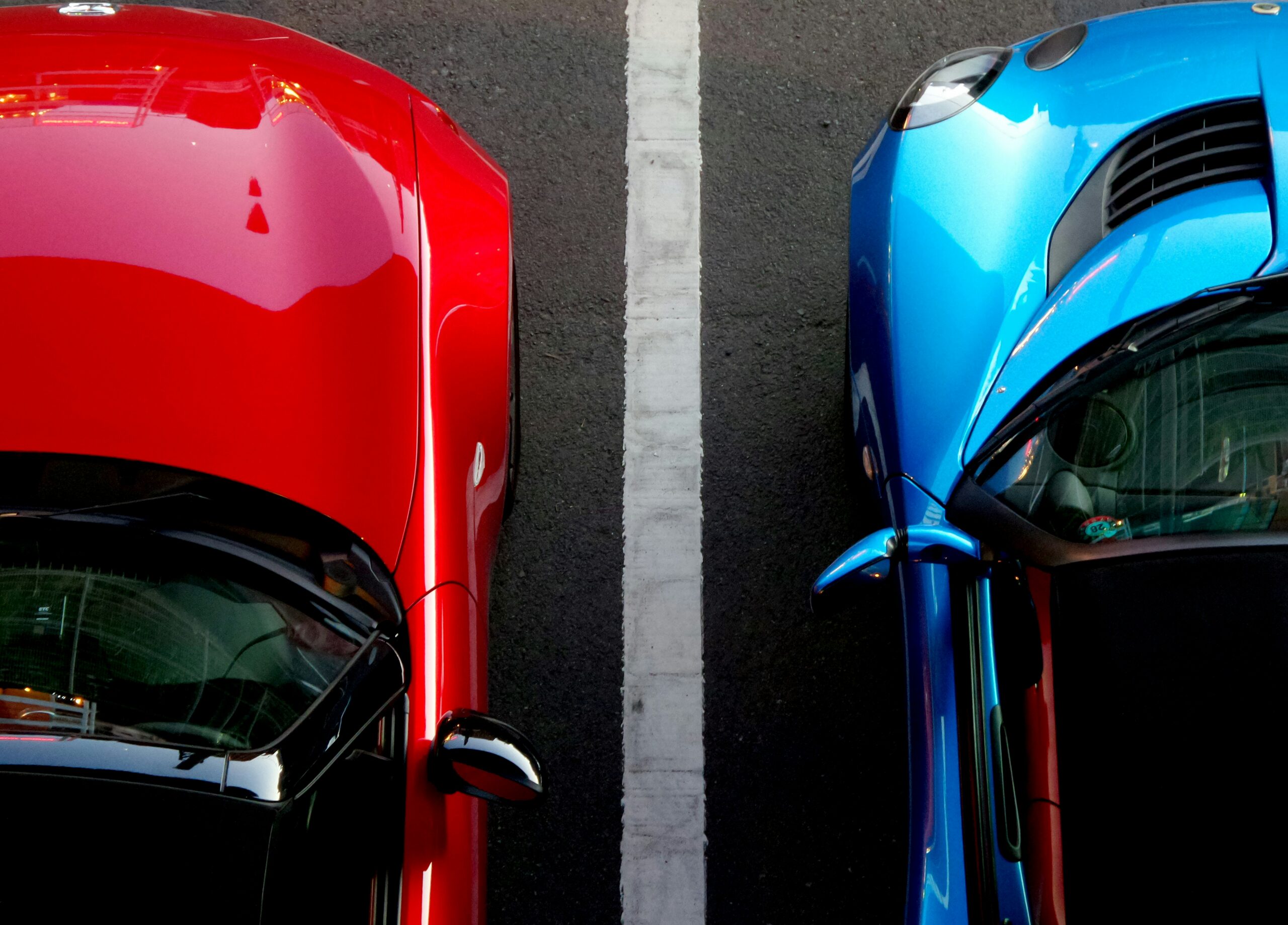 Parking lot with red and blue cars at Oaklawn Hospital.